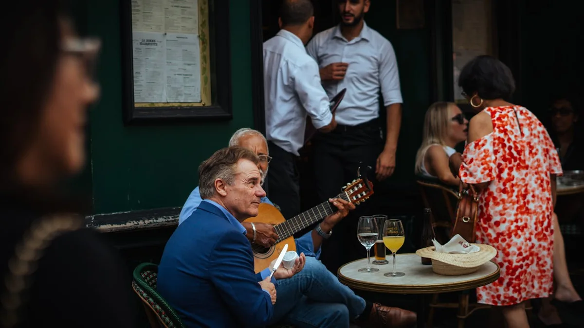 Guests watching a guitarist in a close private flamenco setting
